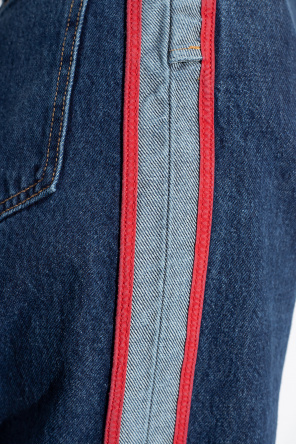 Blue jeans with red sale stripe down the side